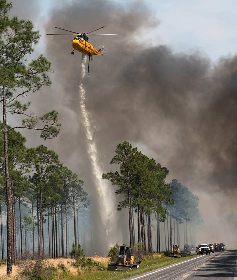 Helicopter supports firing operation on West Mims Fire West Mims Wildfire at Okefenokee NWR. Photo taken during a strategic firing operation along GA 177 in The Pocket near Stephen C Foster SP. Photo Credit: Josh O'Connor - USFWS.