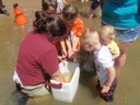 Mussel outreach event in which children are assisting a biologist to release host fish that were recently infested with mussel larvae.